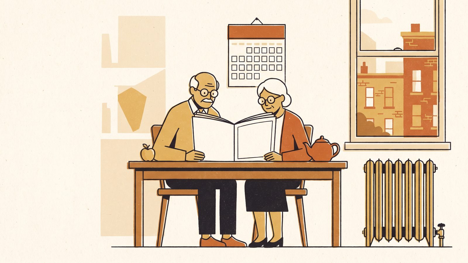 An older couple at a kitchen table in autumn light reading a plan booklet together next to a wall calendar